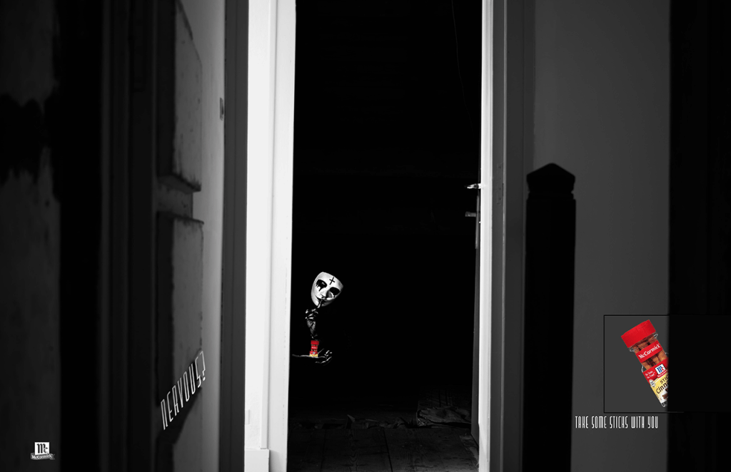 Harlequin in a darkened hallway signalling to stay quiet and take the cinnamon container